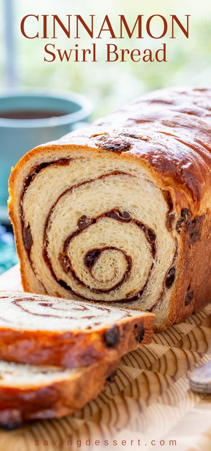 A closeup of a sliced loaf of cinnamon raisin swirl bread