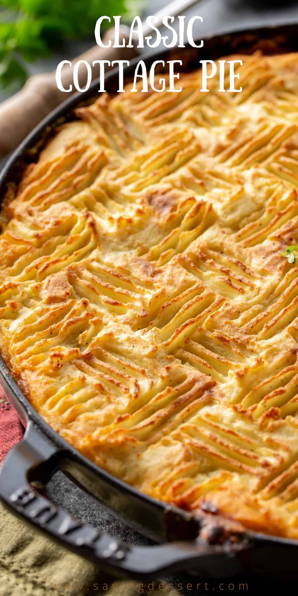 A skillet filled with meaty cottage pie topped with golden brown mashed potatoes