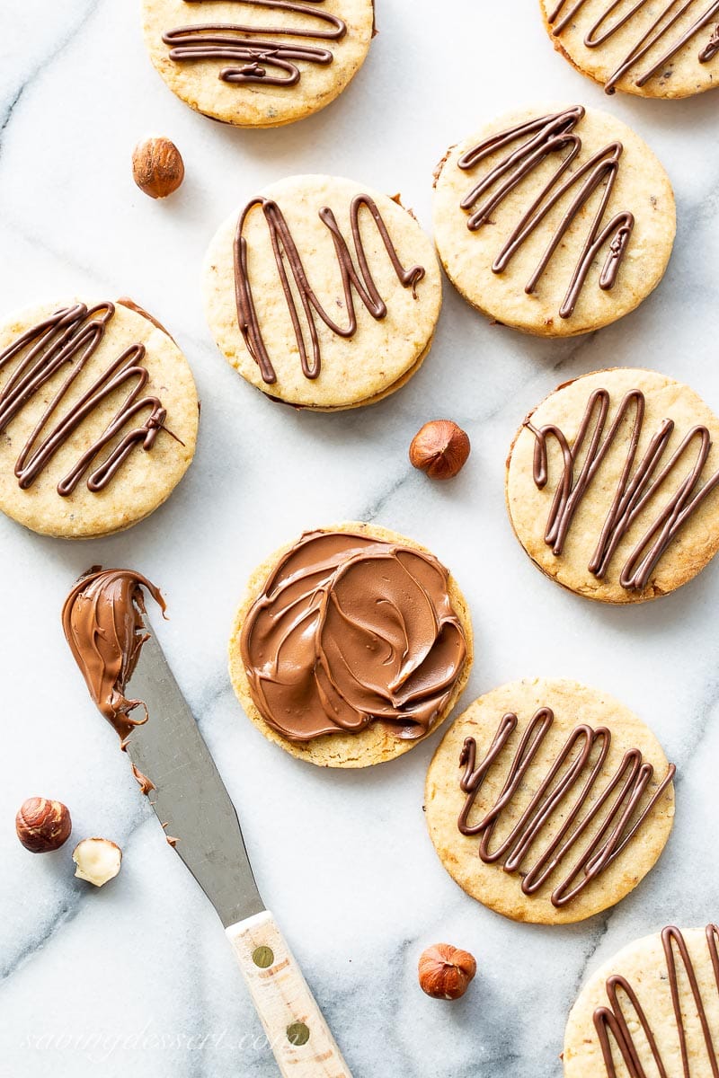 An overhead view of hazelnut cookies slathered with Nutella chocolate spread