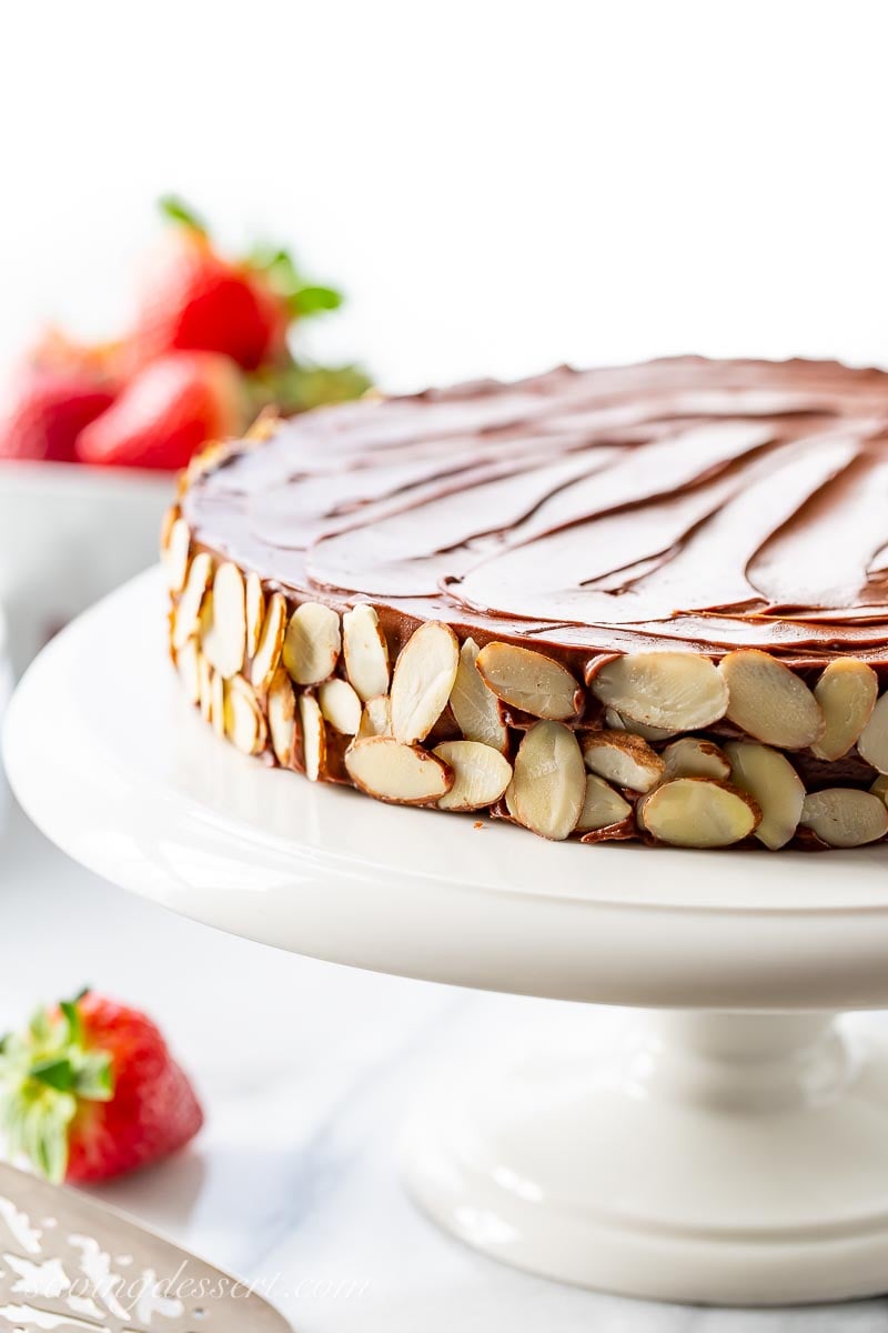 A single layer chocolate cake decorated with sliced almonds