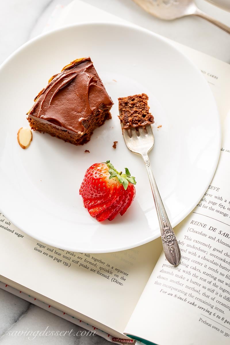 A slice of chocolate almond cake with strawberries