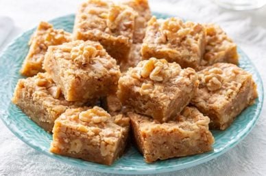 A plate filled with walnut toffee bars