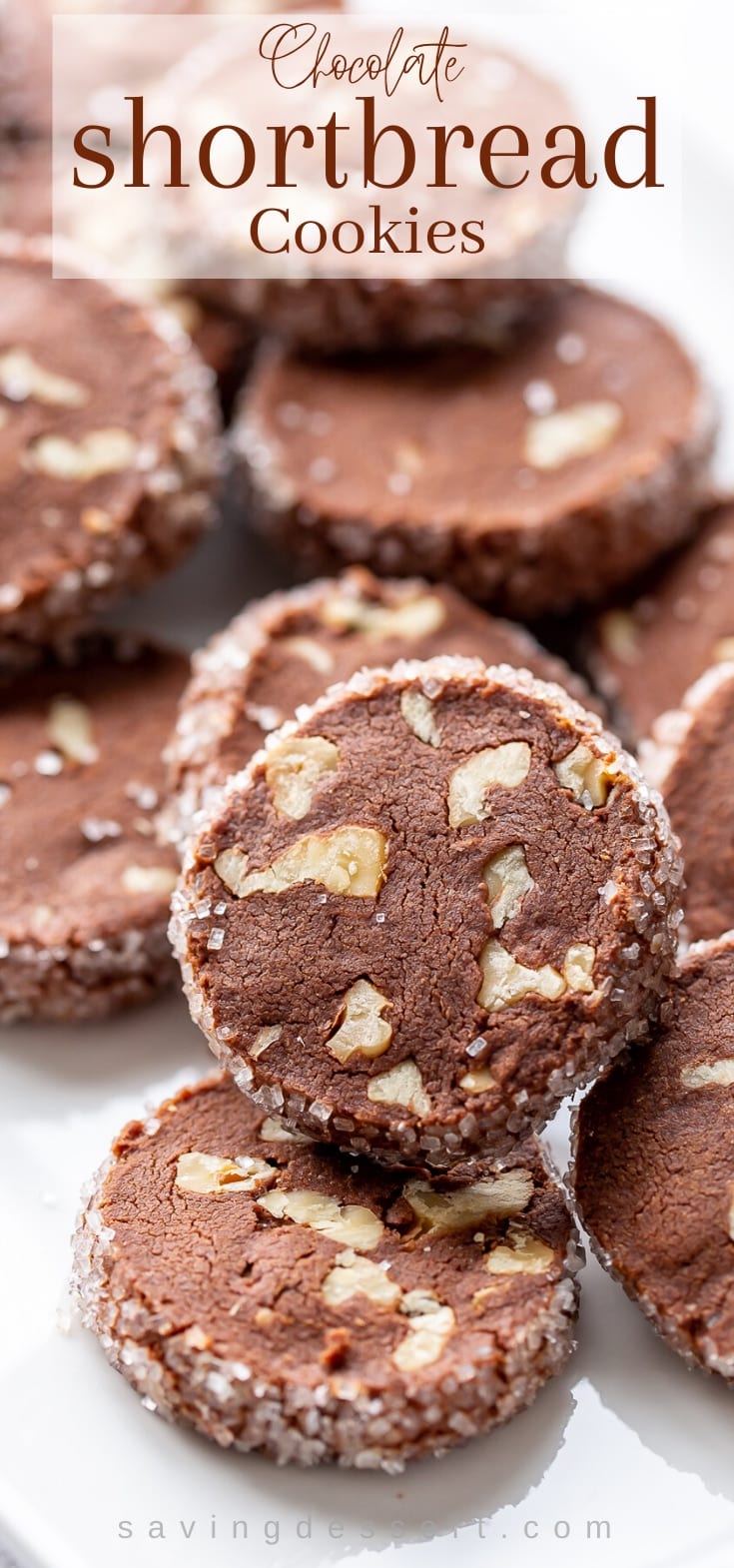 A plate piled with chocolate shortbread cookies with walnuts