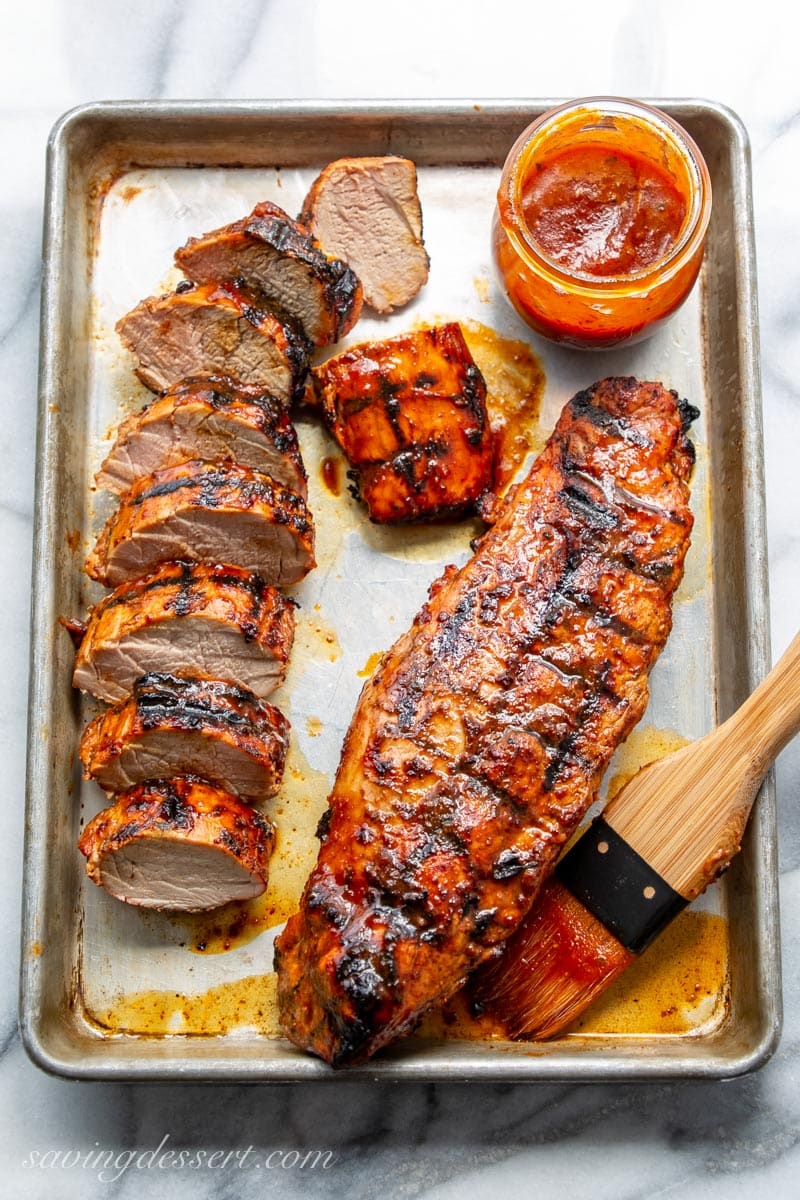 A pan with a sliced BBQ pork tenderloin