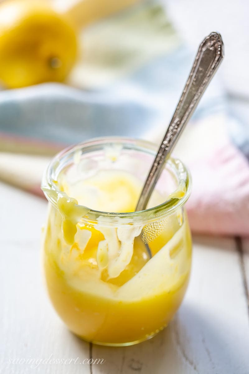 A small jar of lemon curd with a spoon