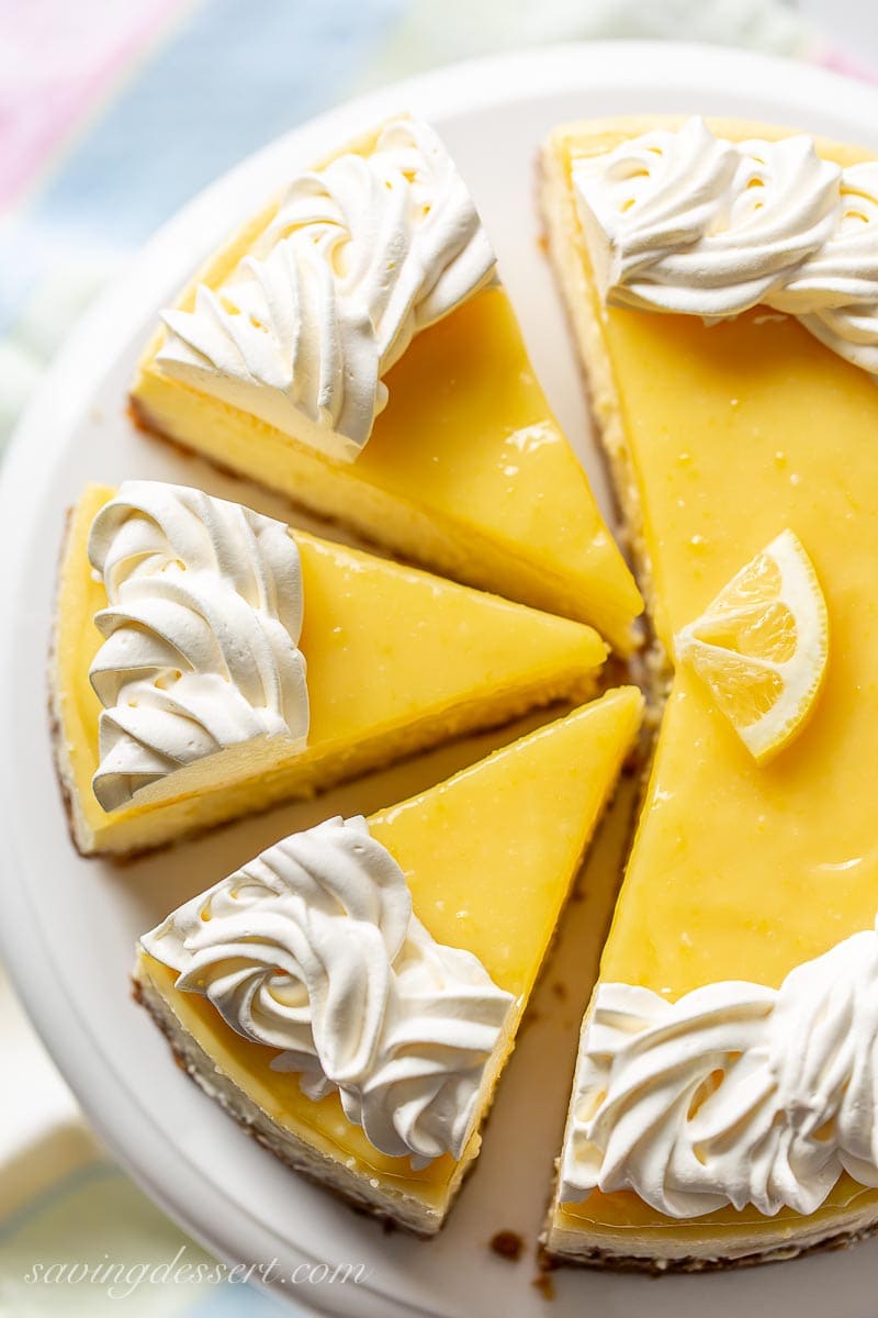 An overhead view of a sliced lemon curd topped cheesecake