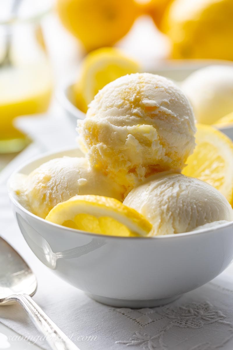 A close up of scoops of ice cream with lemons