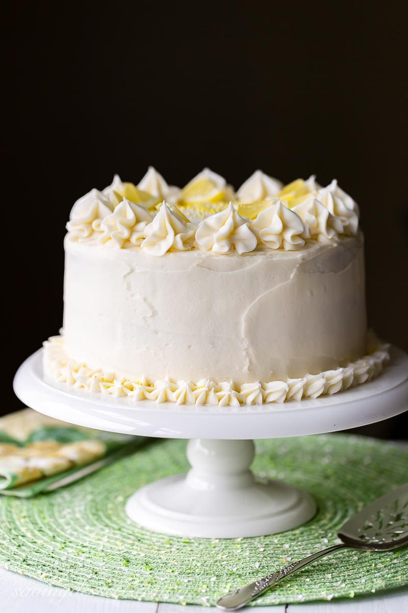 A side view of a lemon layer cake with cream cheese icing
