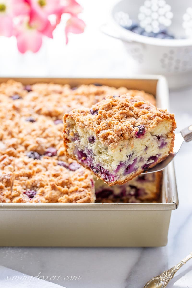 A sliced blueberry coffee cake with streusel topping