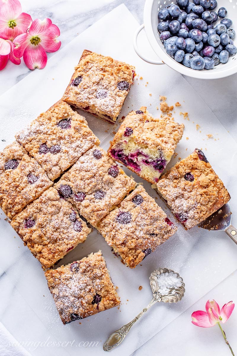 A sliced blueberry coffee cake dusted with powdered sugar