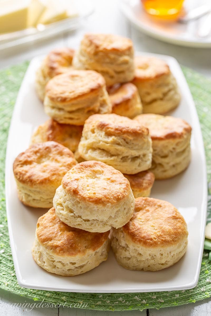 A platter stacked with flaky homemade biscuits