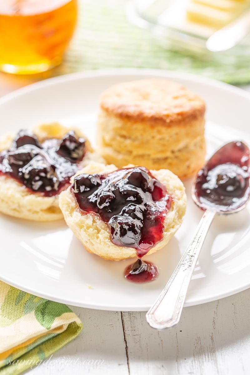 Buttermilk biscuits topped with a big scoop of blueberry preserves