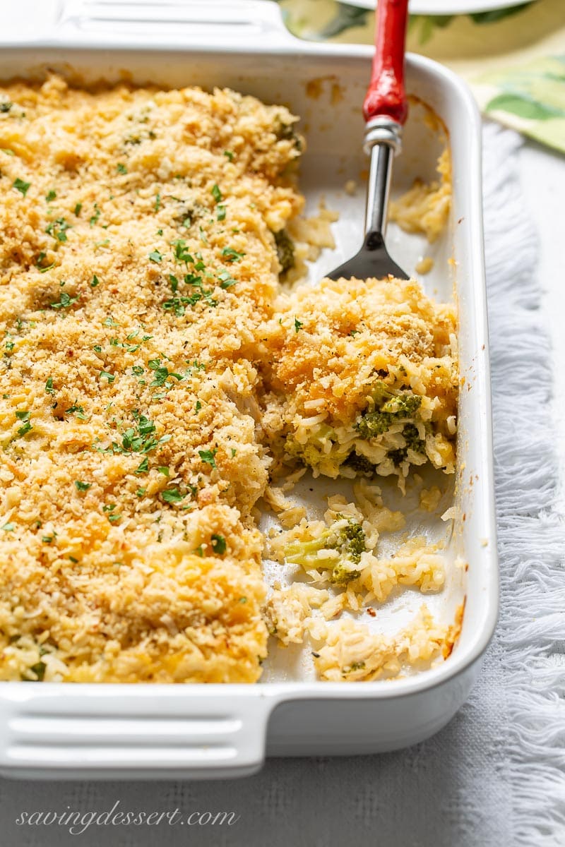 A casserole dish with a scoop of chicken and broccoli