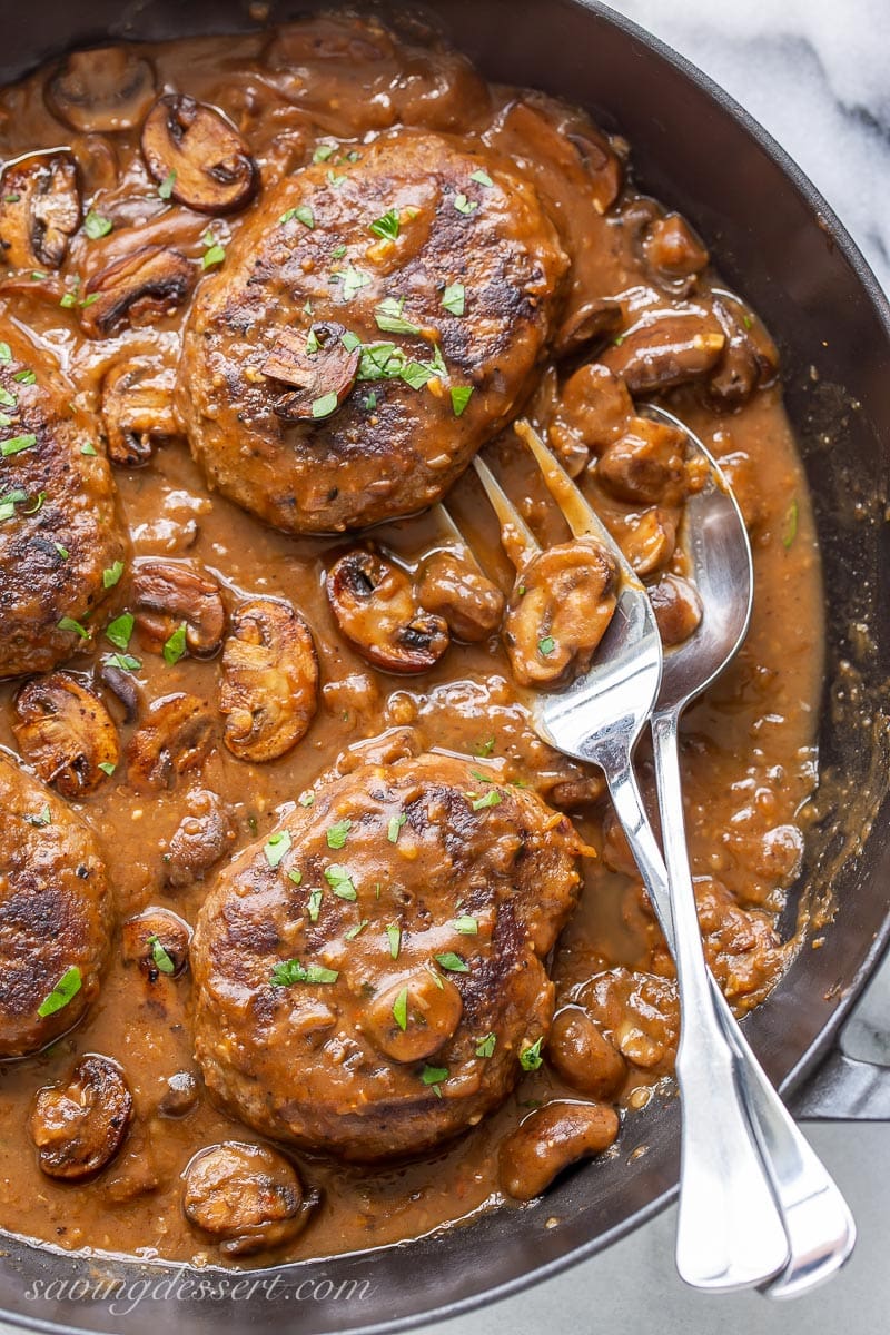 Tender beef patties in a thick mushroom gravy garnished with parsley