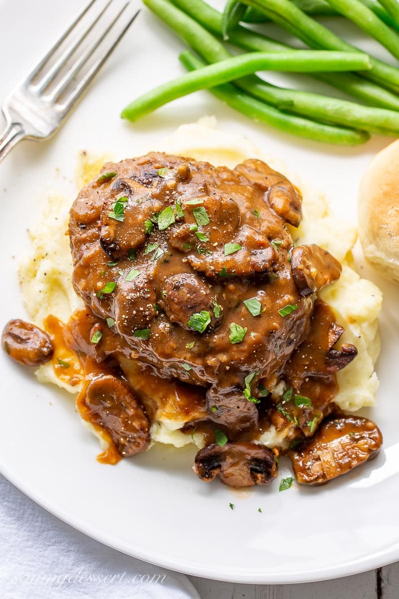 An overhead view of Salisbury Steak with mushroom gravy served over mashed potatoes