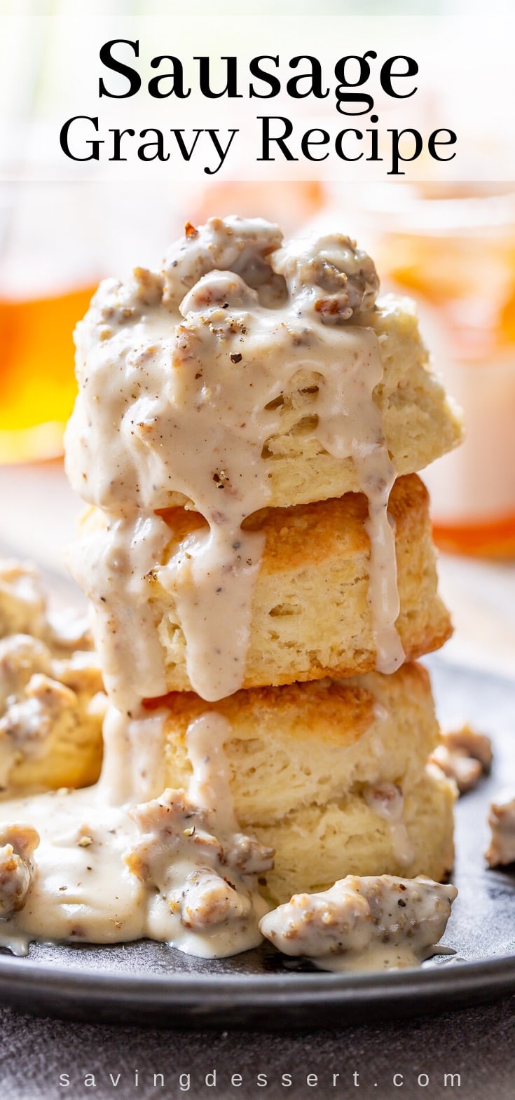 A stack of biscuits covered in sausage gravy