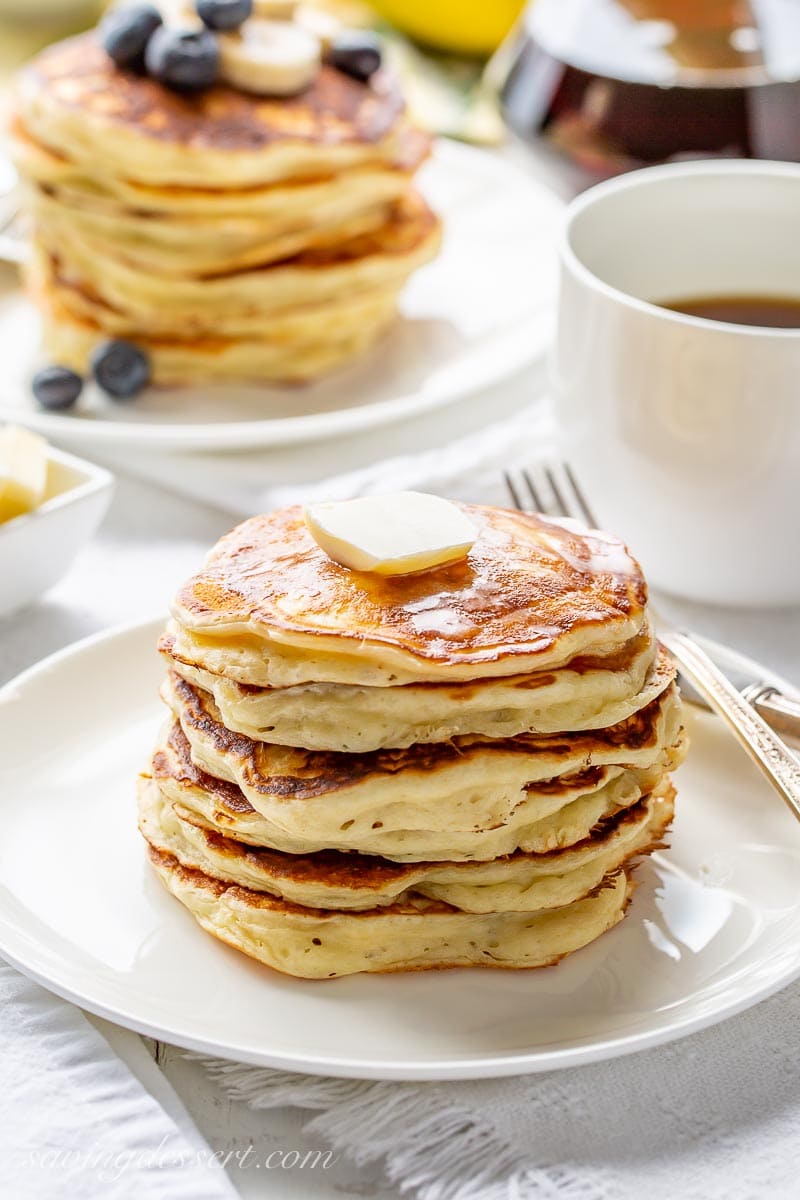 A stack of buttermilk pancakes with a pat of butter on top