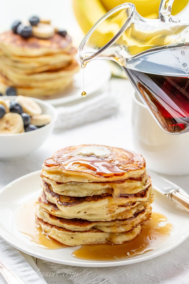 A stack of pancakes drizzled with maple syrup