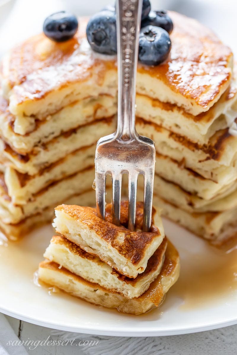 A fork full of fluffy buttermilk pancakes