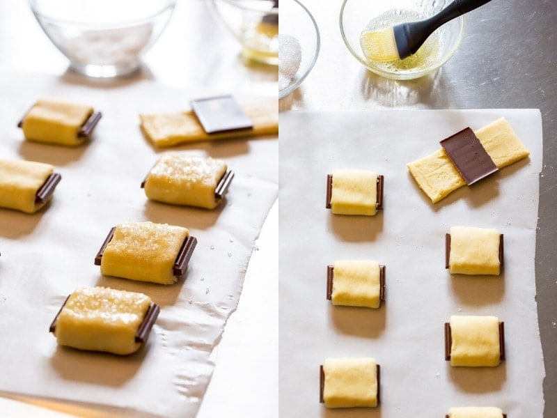 Chocolate croissant cookies being made by wrapping dough around chocolate pieces.