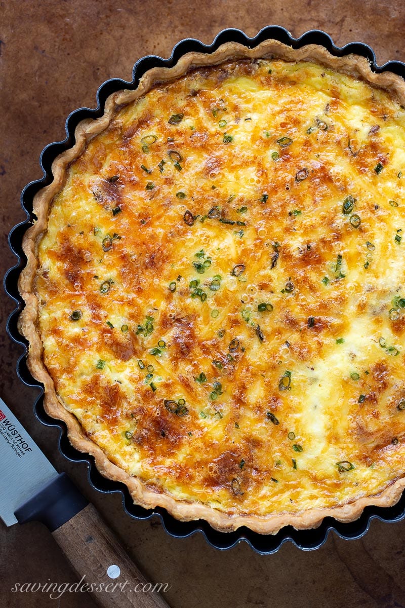 Overhead view of a baked quiche lorraine on a baking sheet
