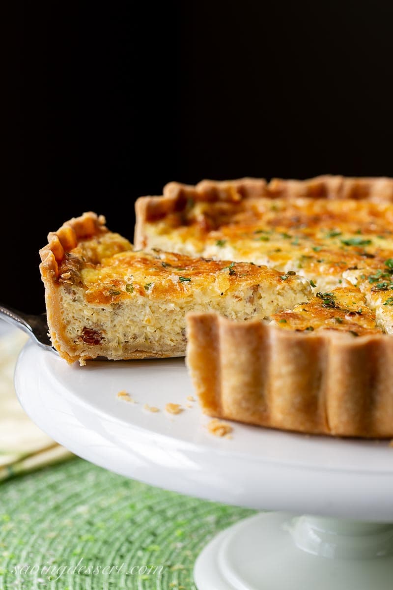 A sliced quiche on a cake stand 