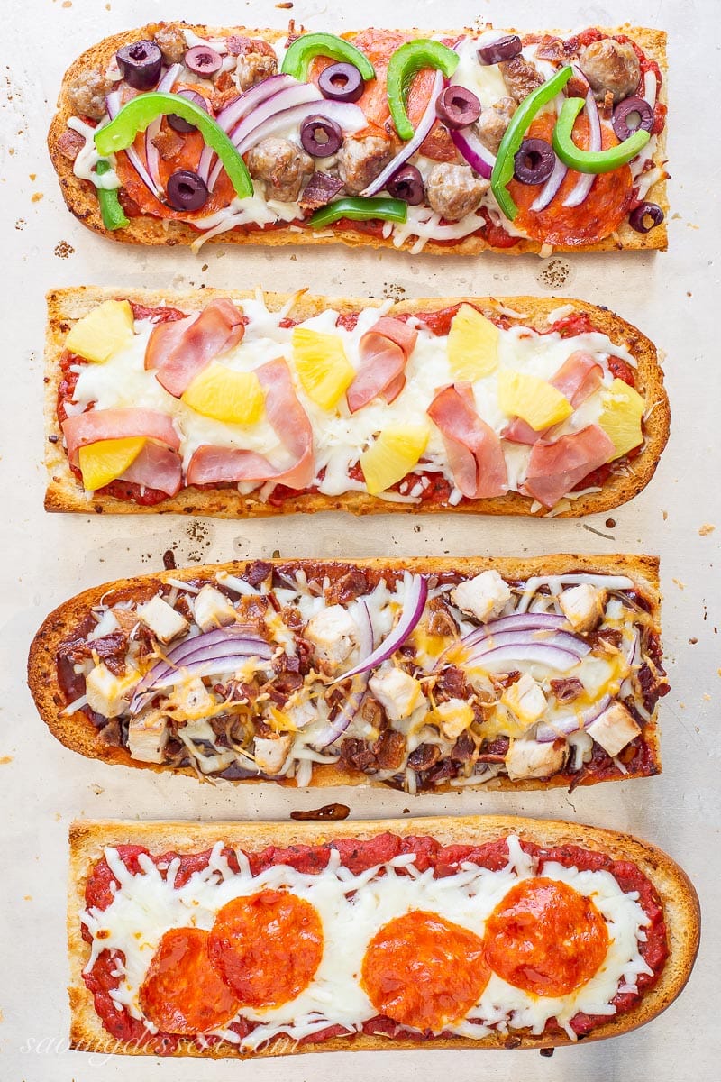 baked French bread pizzas on a pan