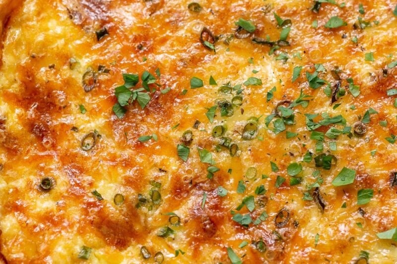 An overhead view of a whole Quiche Lorraine hot from the oven.