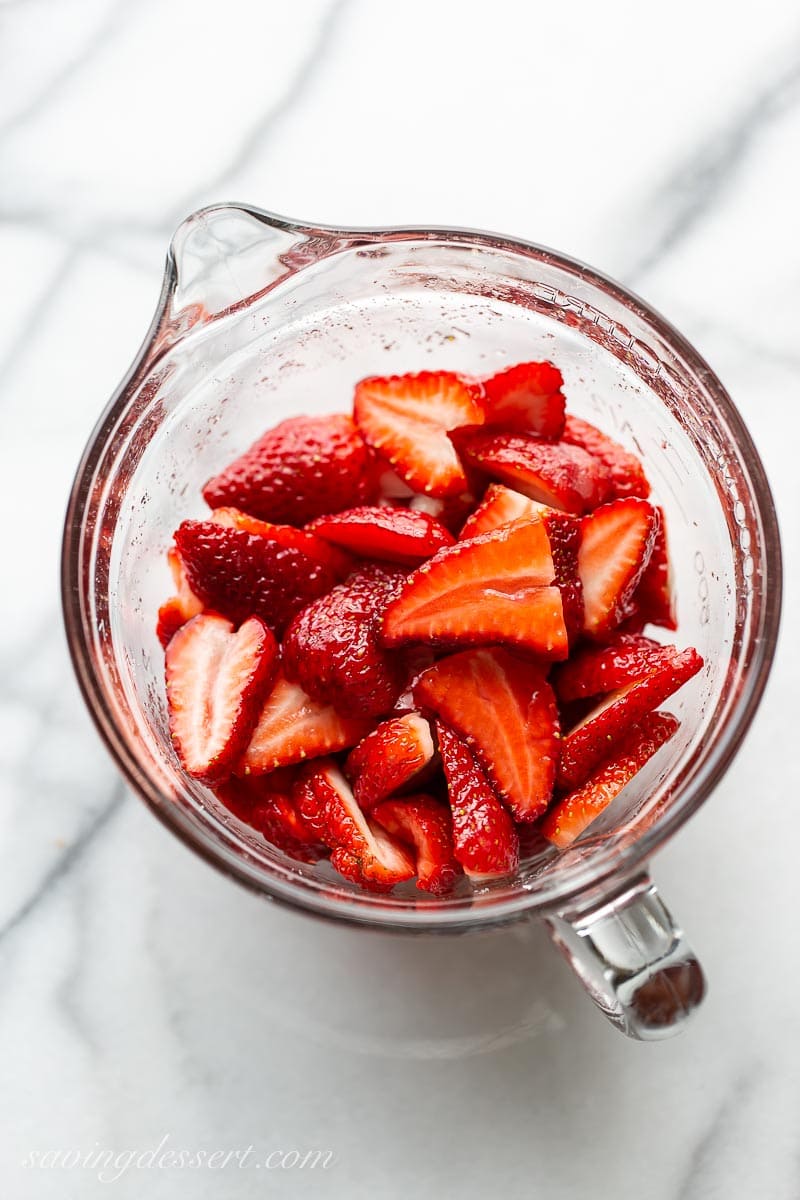 A bowl of sliced strawberries with mixed with sugar