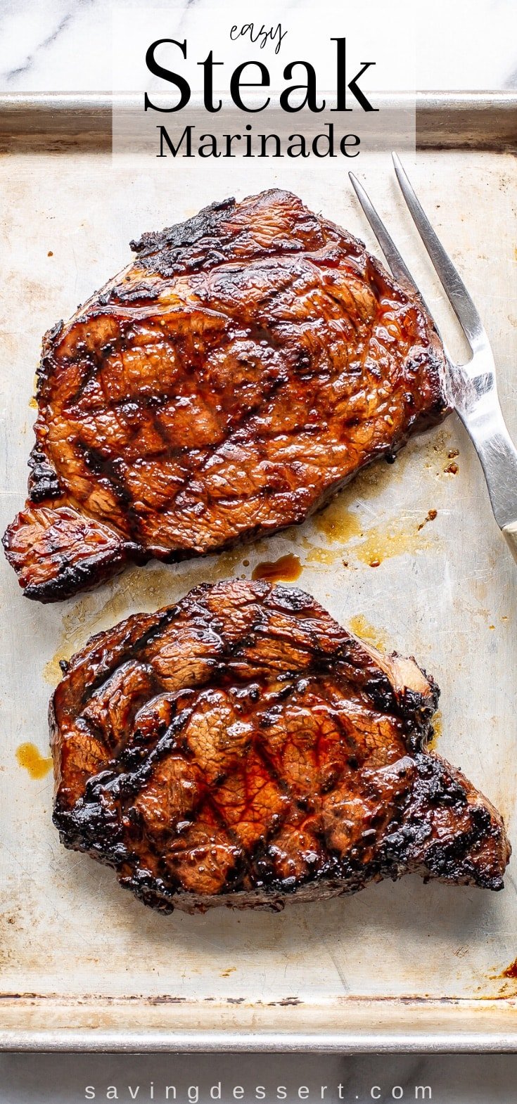 Two large, juicy grilled ribeye steaks on a small baking pan