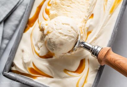 A pan filled with creamy caramel ice cream in a scoop