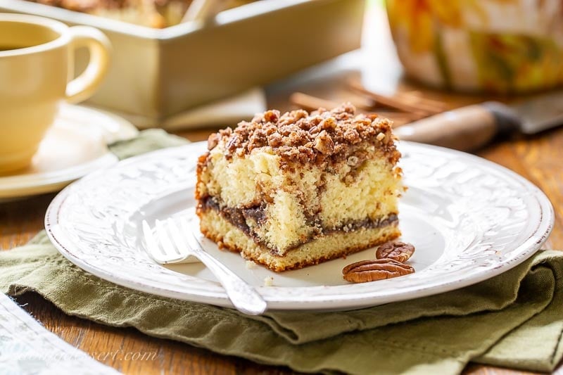 A square slice of cinnamon coffee cake on a plate