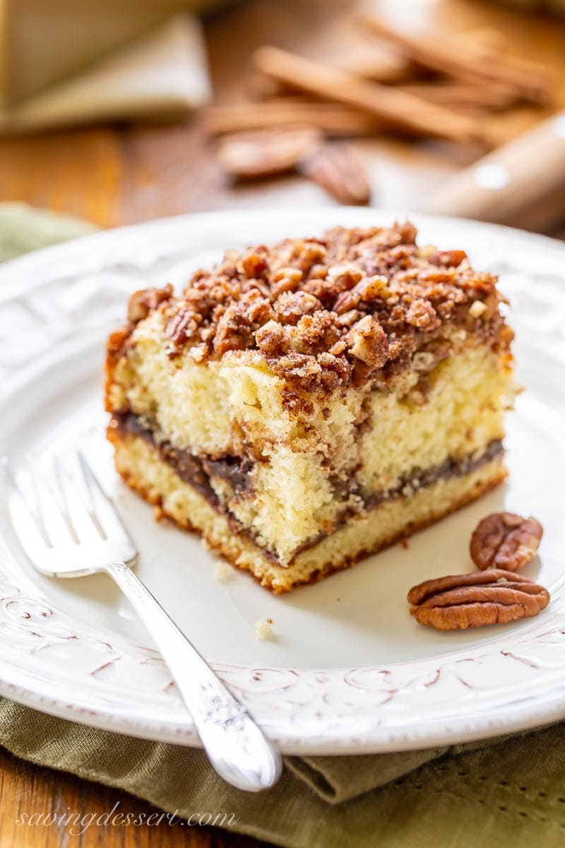 A square piece of cinnamon pecan coffee cake on a plate