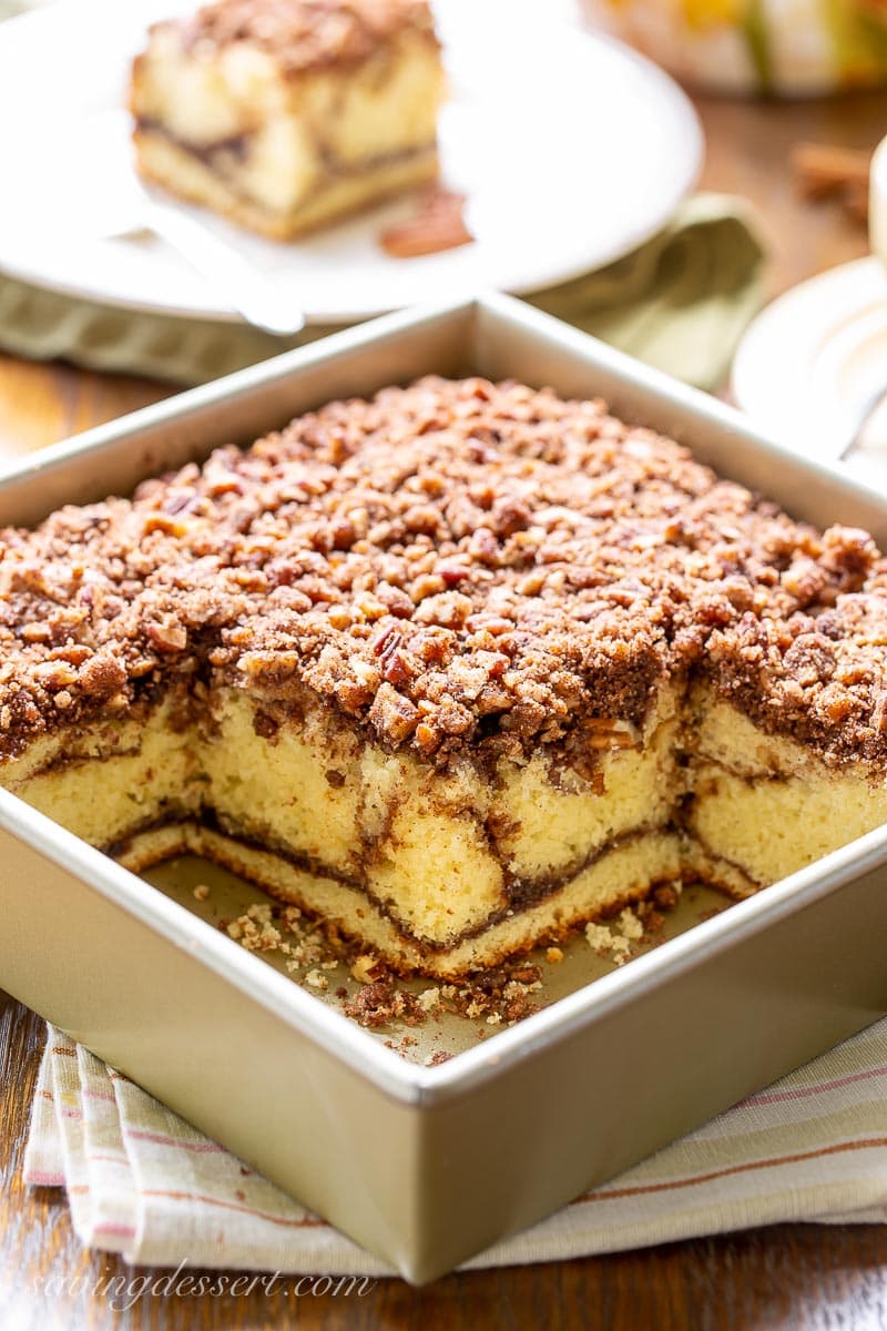 A square pan with sour cream coffee cake topped with pecan streusel