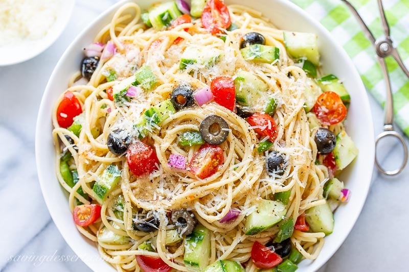 An overhead view of a bowl of pasta salad with fresh grated Parmesan