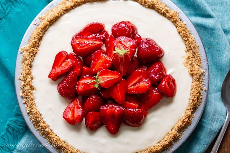 A simple cream cheese pie topped with sweetened fresh strawberries.