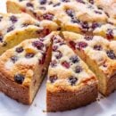 A sliced single layer blackberry cake with a crunchy sugary top