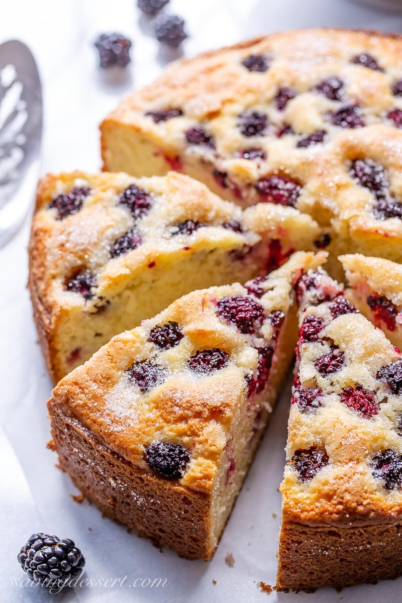 A sliced blackberry cake with a sugary top