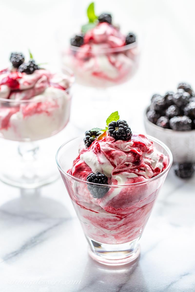 Clear glasses filled with a blackberry puree folded into whipped cream. Garnished with fresh blackberries and fresh mint leaves
