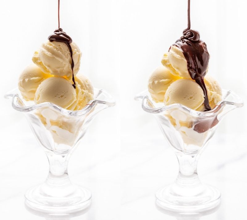 Two glasses of ice cream being drizzled with chocolate sauce