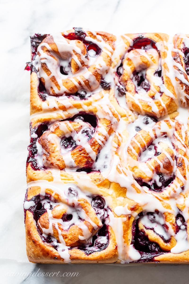 An overhead view of a square bunch of blueberry rolls