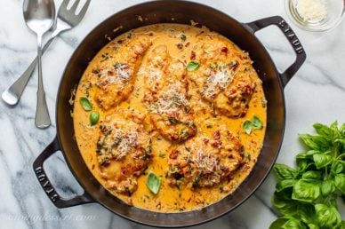 A skillet of sun-dried tomato chicken with basil and Parmesan