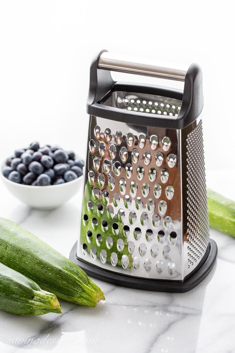 A large box grater with on a marble top