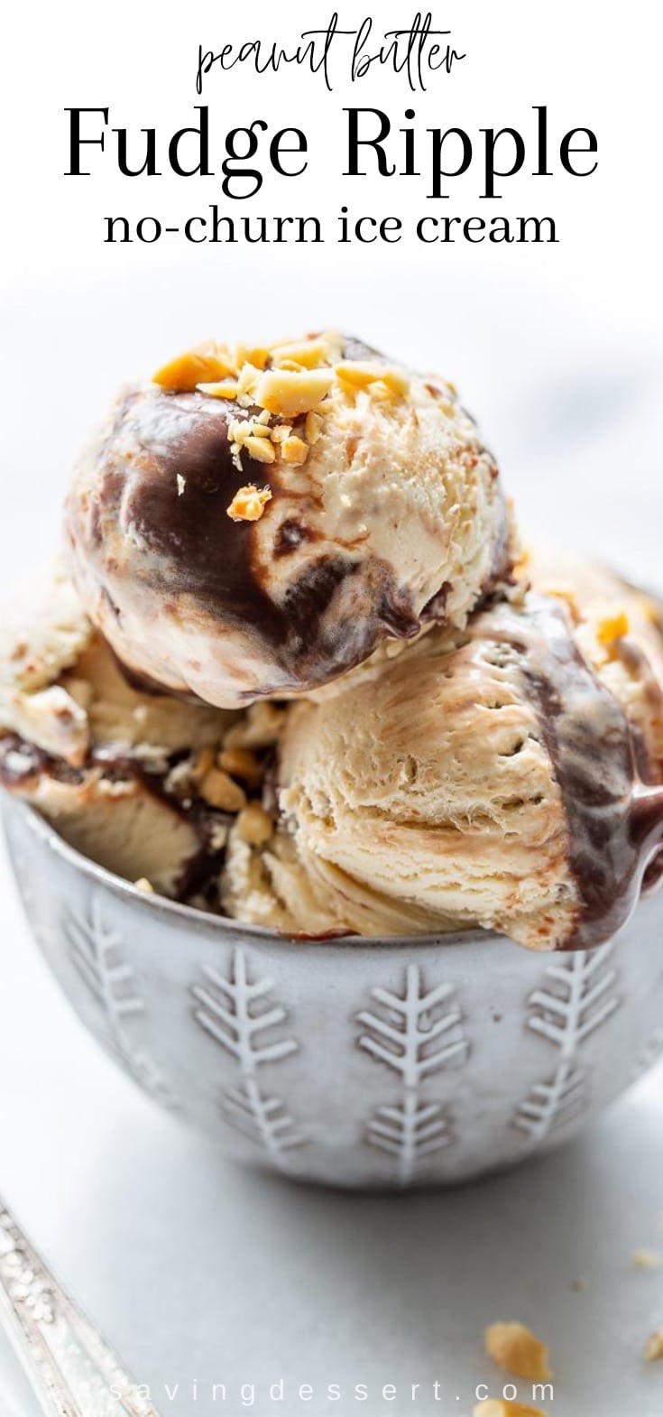 A bowl filled with scoops of peanut butter fudge ripple no-churn ice cream topped with chopped peanuts