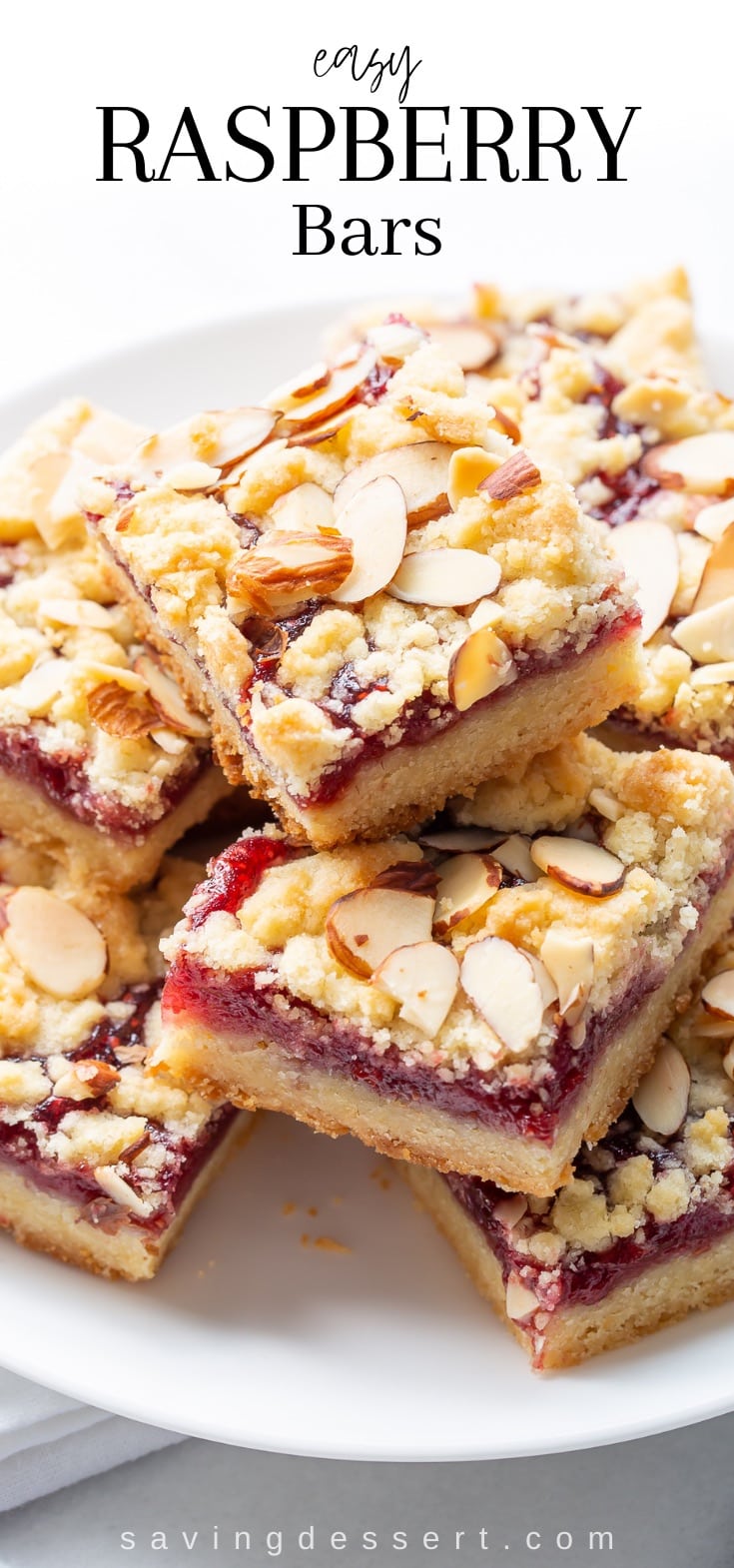 Raspberry squares in a stack with almonds on top