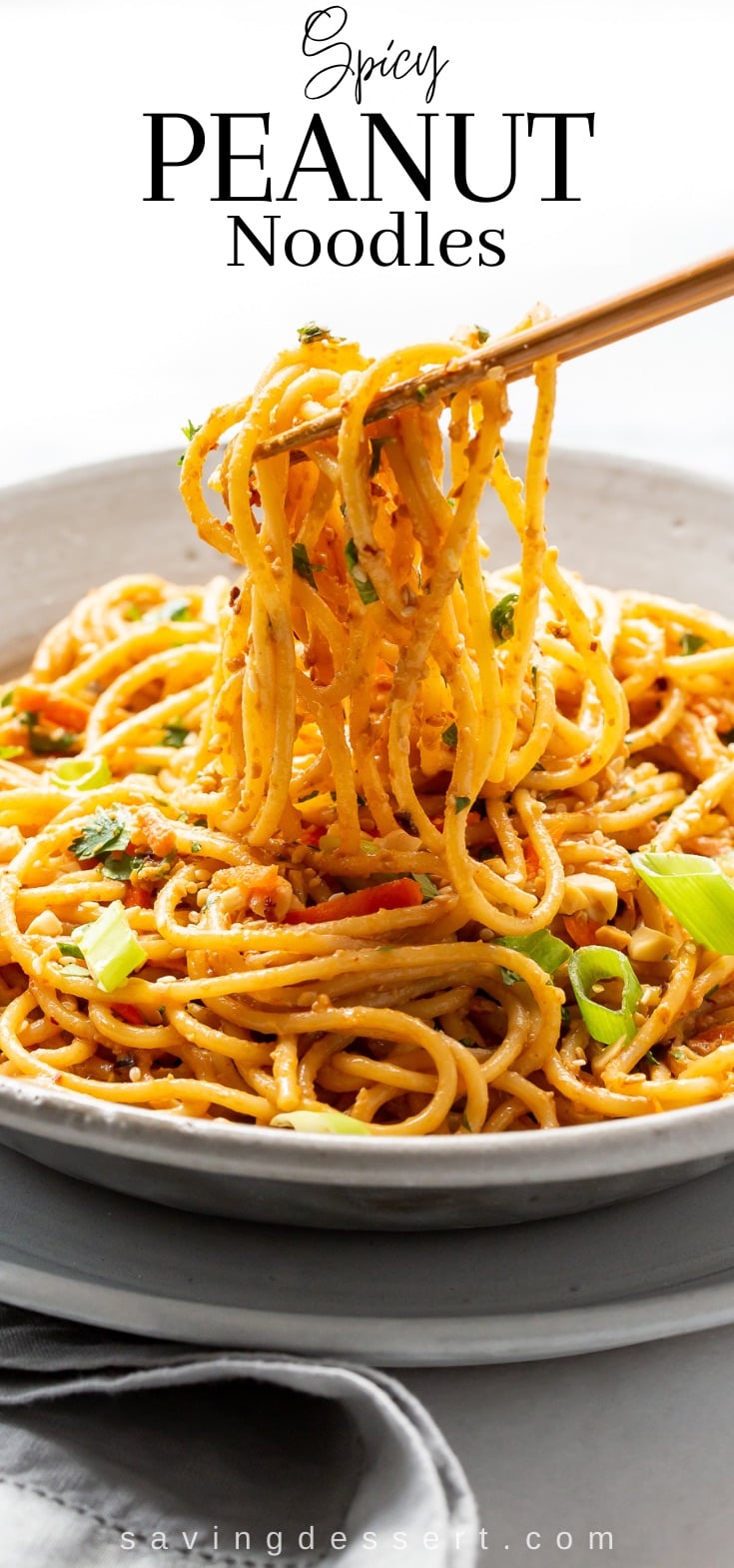 A bowl of spaghetti noodles coated in a spicy peanut sauce