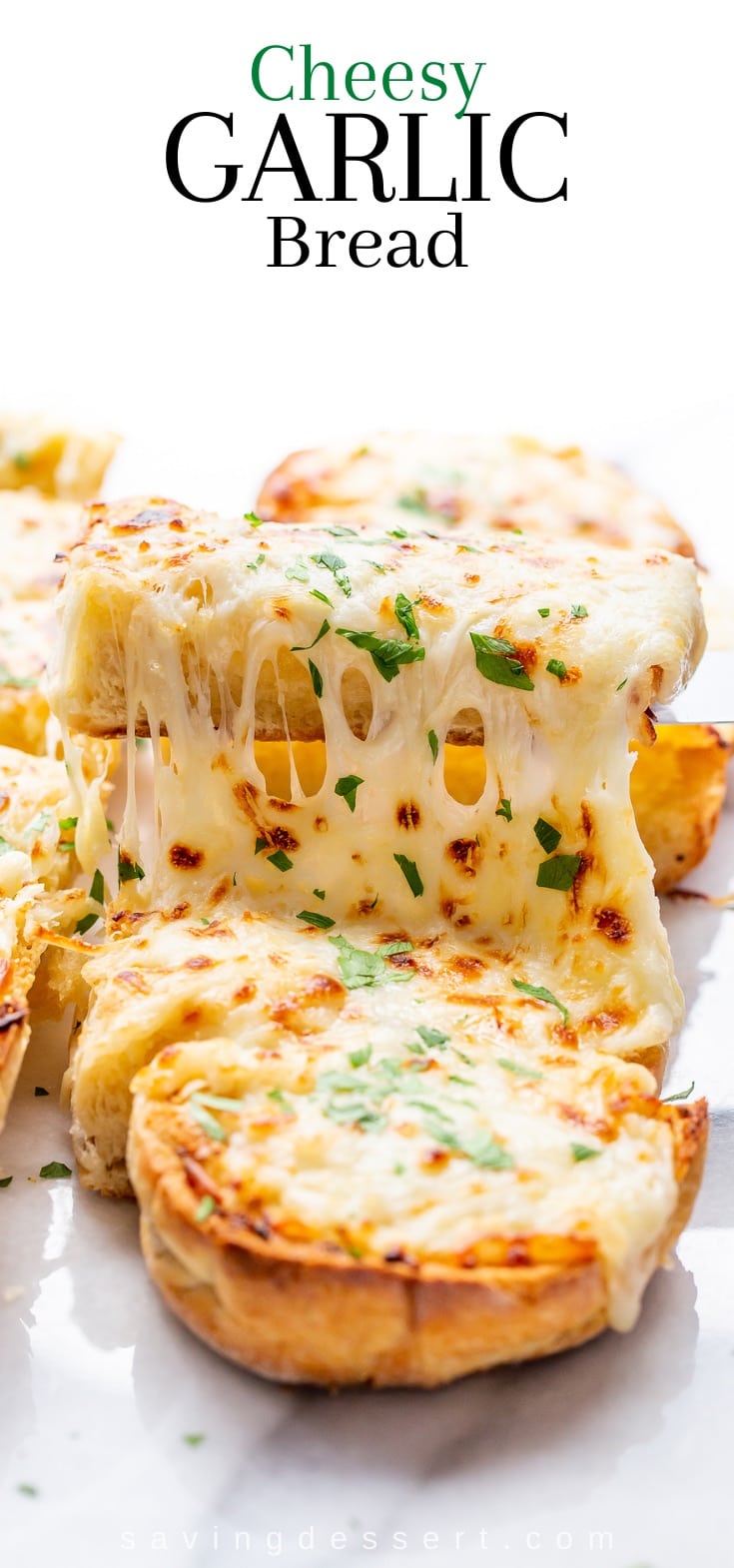 Sliced garlic bread topped with melted cheese and parsley