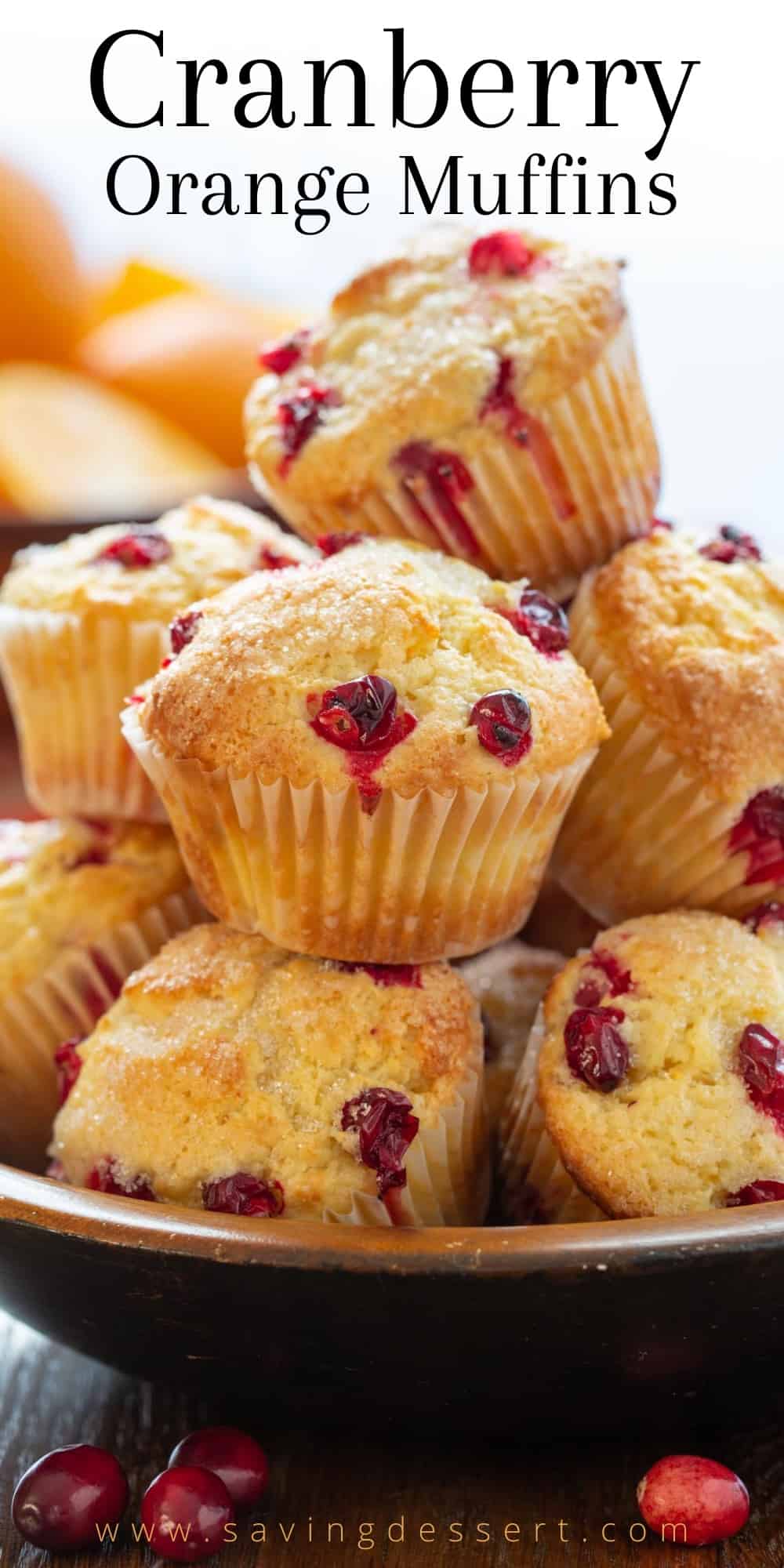 A bowl overflowing with fresh baked cranberry orange muffins