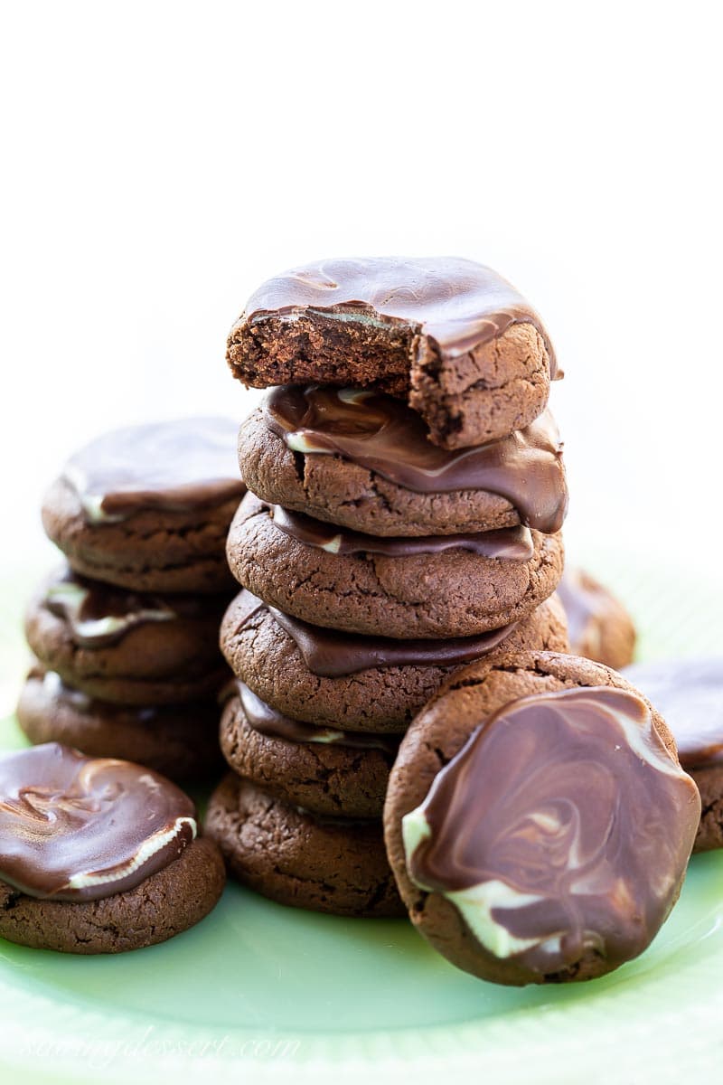 A stack of chocolate mint cookies with mint filled chocolate spread on top