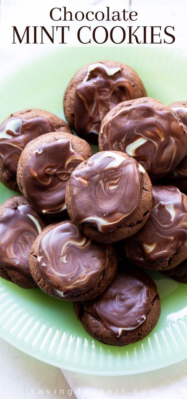 A close up of a plate of chocolate cookies topped with a melted chocolate Andes mint